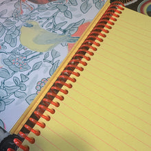 Load image into Gallery viewer, Notebook with yellow lined pages and red spiral binding on a floral fabric background
